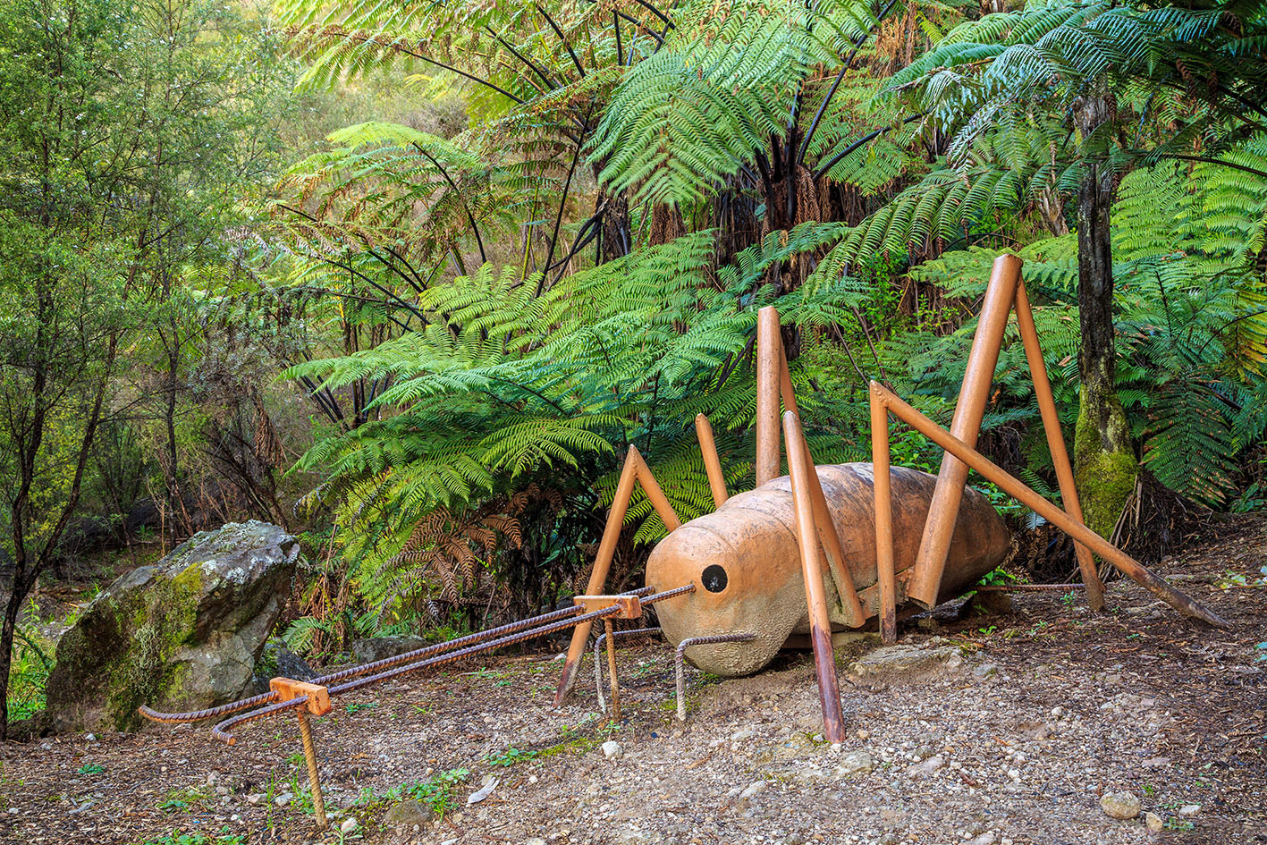 A metal sculpture of a weta a New Zealand insect in Te Puna Quarry Park Te Puna New Zealand